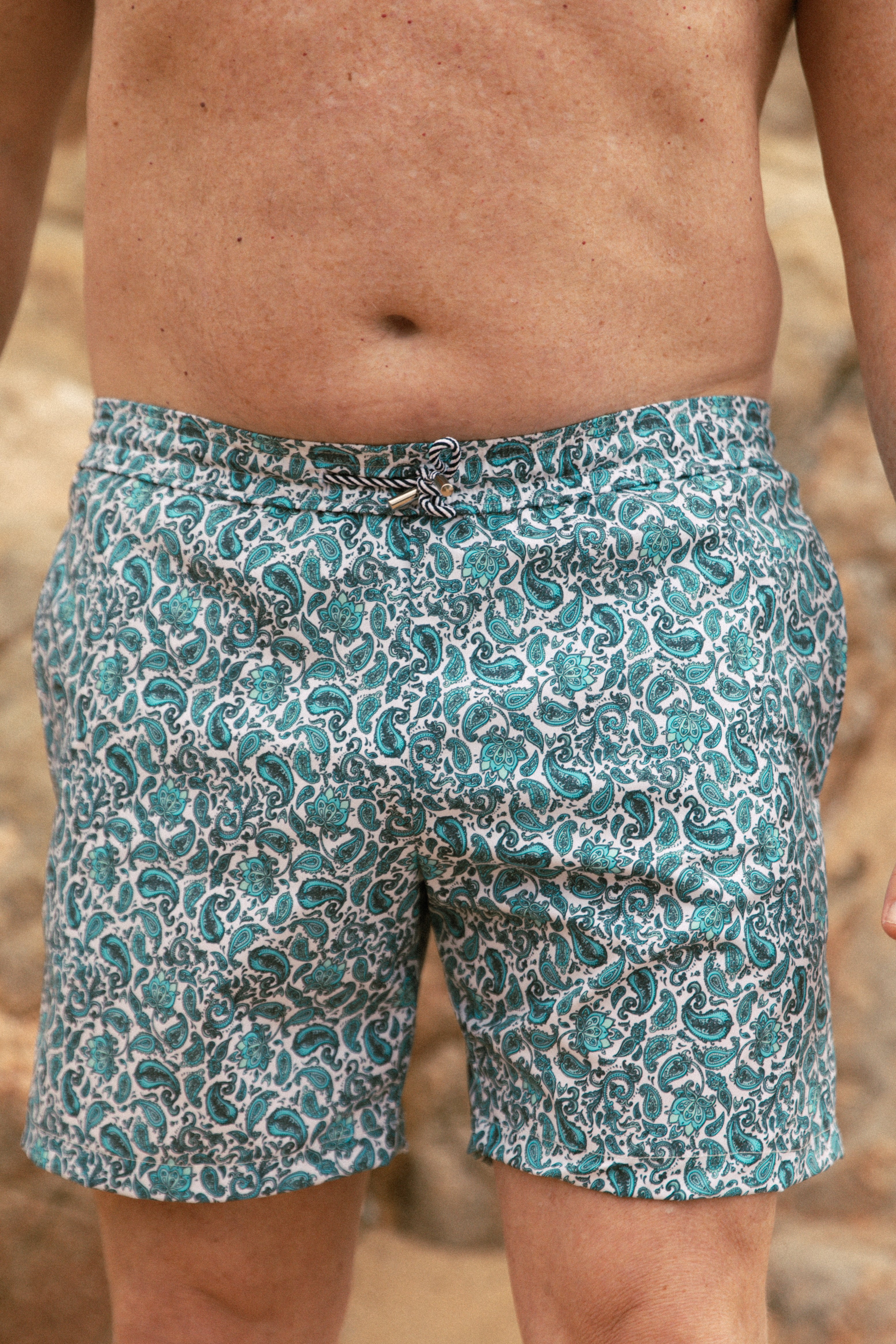 Detail of model wearing printed blue swimsuit AQVA Swimwear