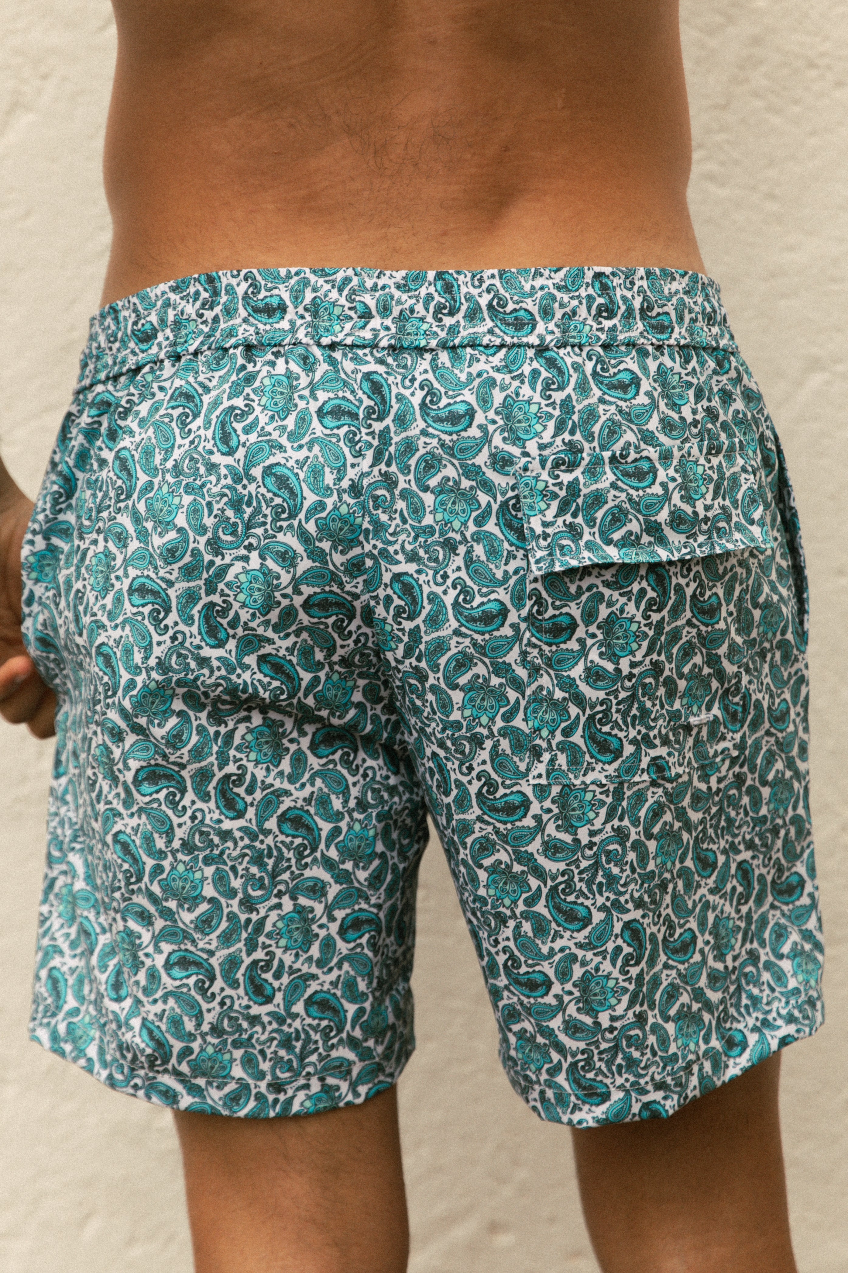 Detail of model wearing printed blue swimsuit from behind AQVA Swimwear