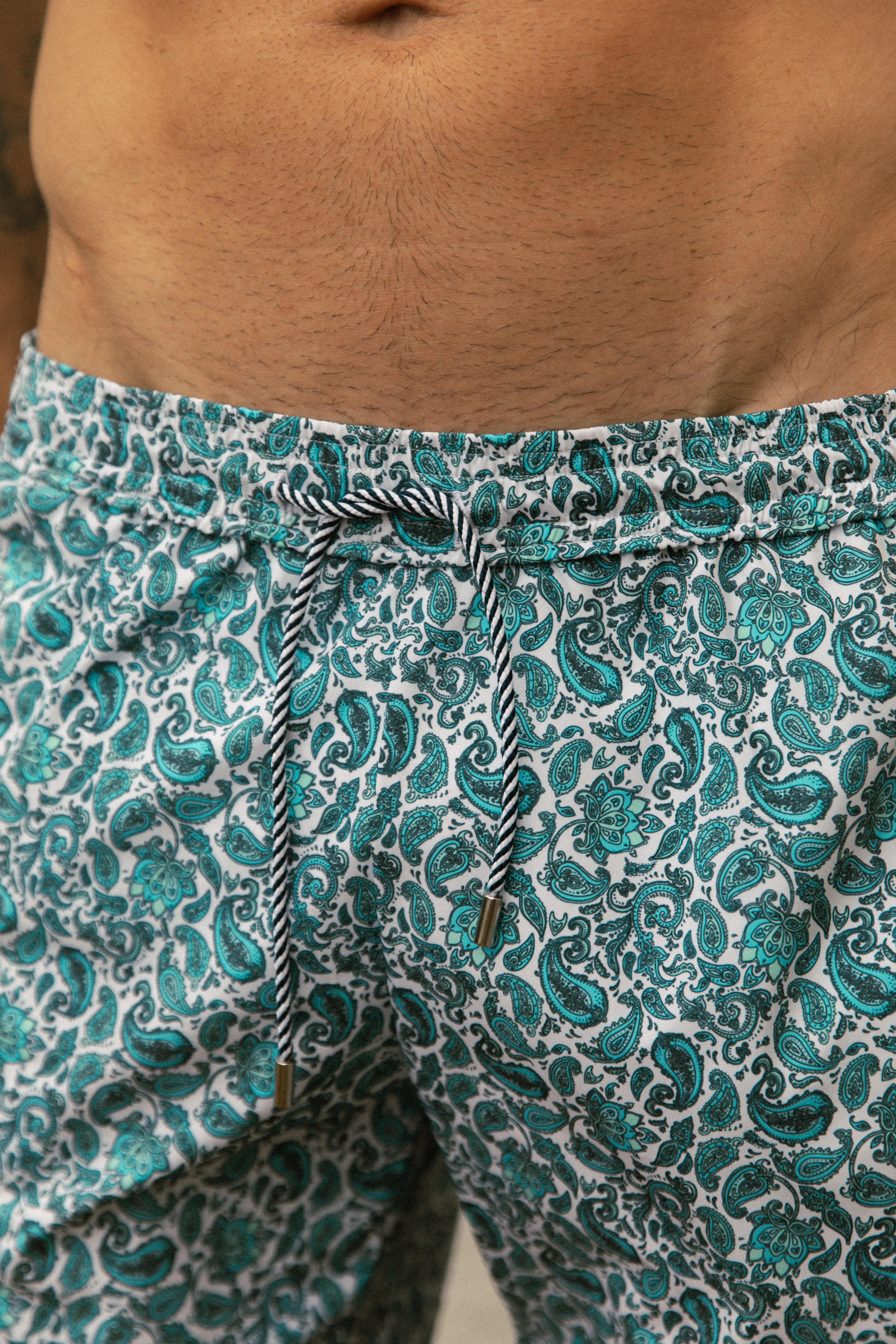 Detail of model wearing printed blue swimsuit AQVA Swimwear