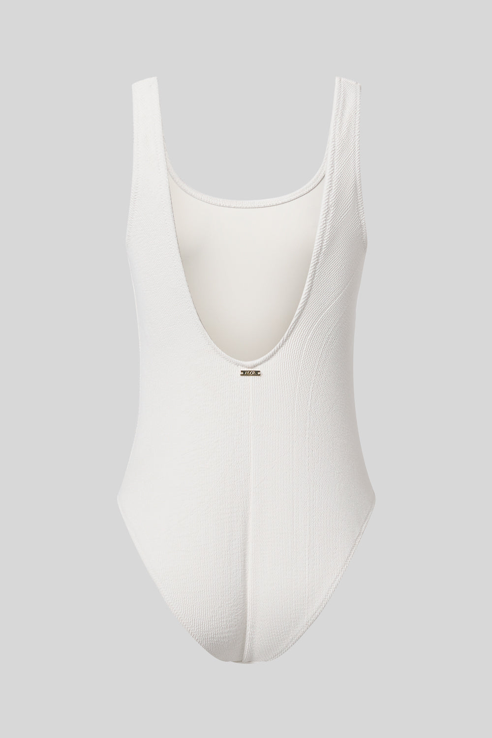 Light nude swimming costume on her back by AQVA Swimwear
