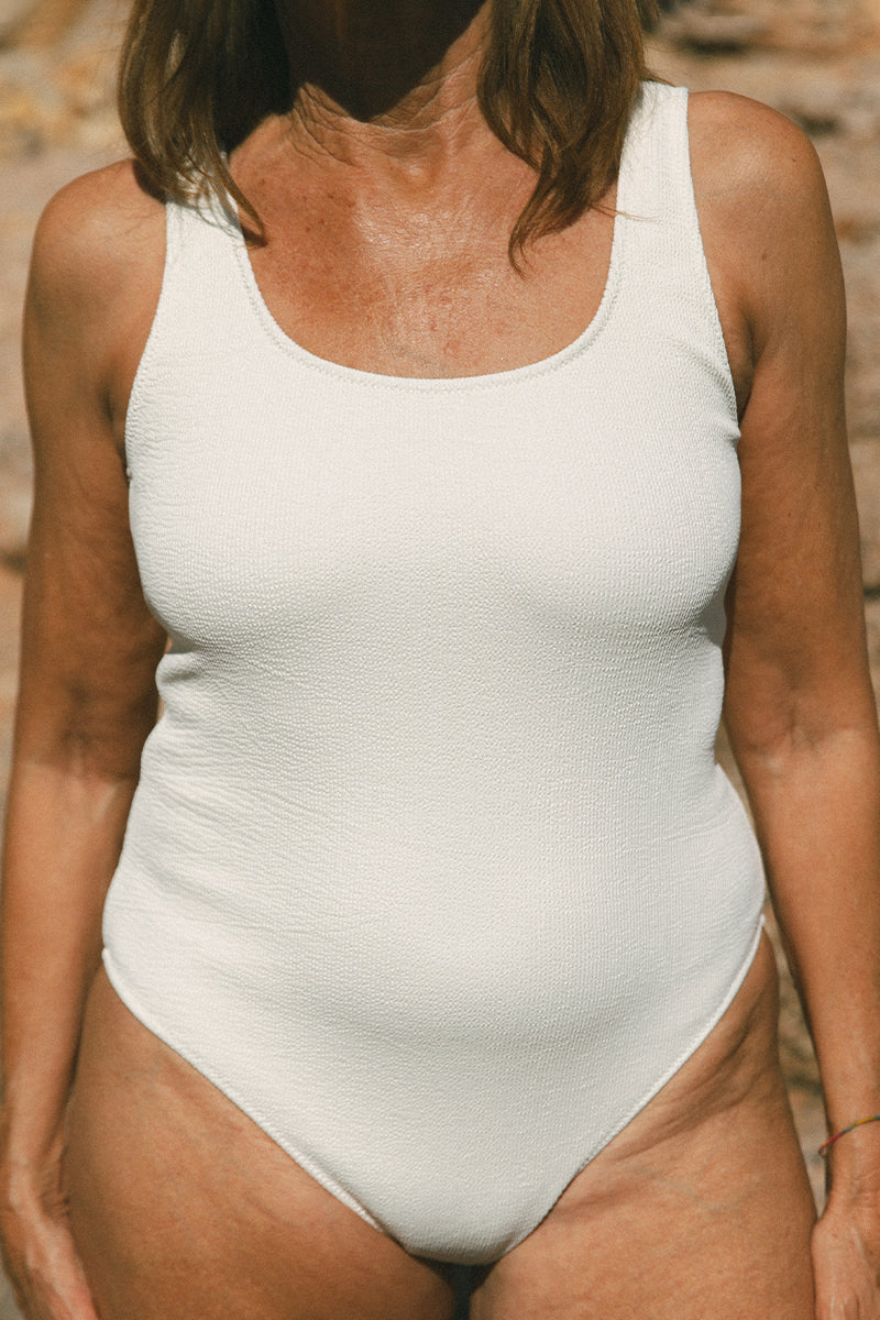 Detail of model wearing light nude swimming costume by AQVA Swimwear